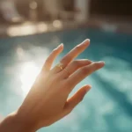 woman removing gold ring before swimming in pool