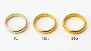 Three gold rings in 9ct, 18ct and 24ct showing the colour difference between gold carats