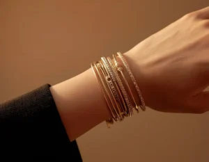 Woman's wrist wearing stacked gold and silver bracelets to show mixed metal jewellery styling