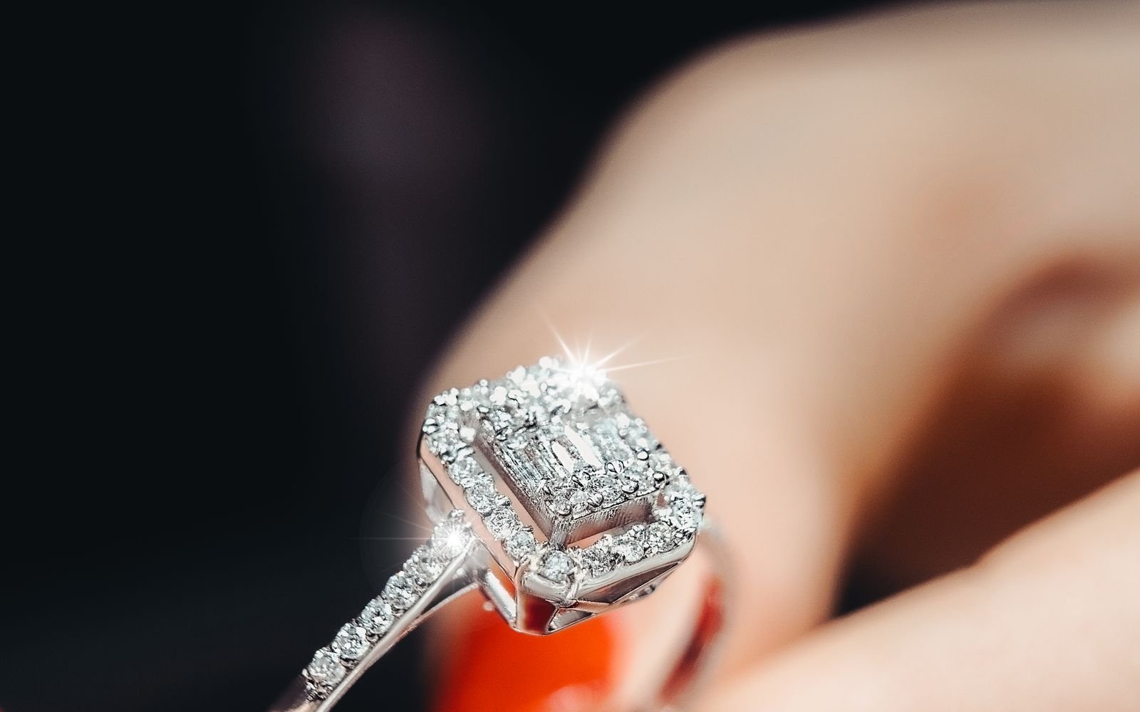 Sparkling diamond engagement ring held close up