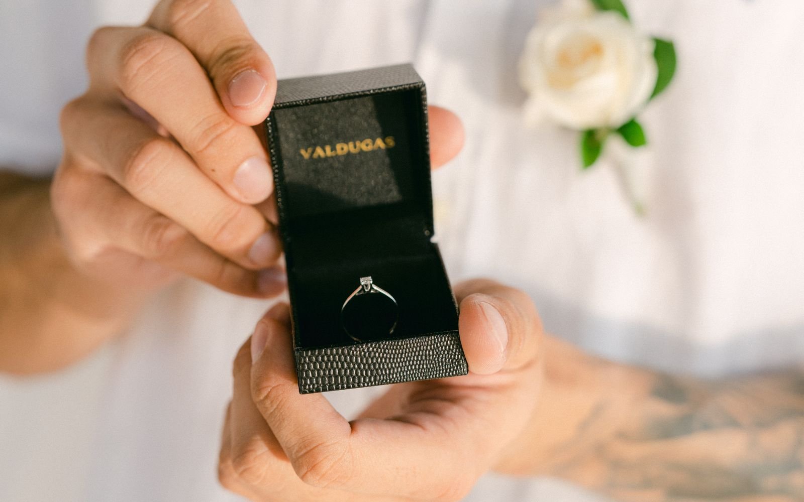 Man holding engagement ring box during proposal