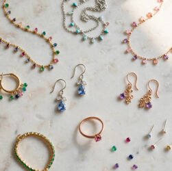 Assorted gold, silver and rose gold fashion jewellery pieces on marble